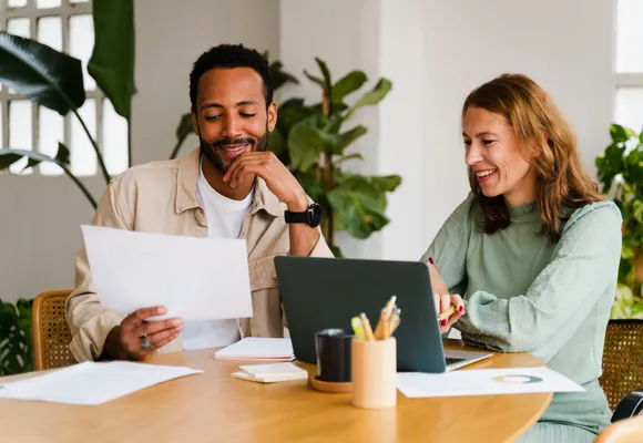 Two business owners reviewing a report together
