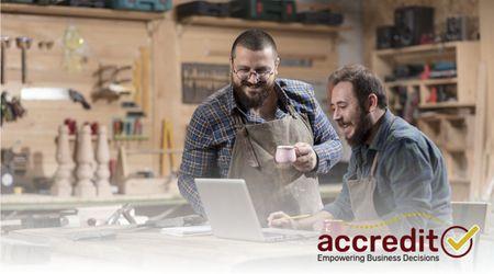 Two men working on a laptop.