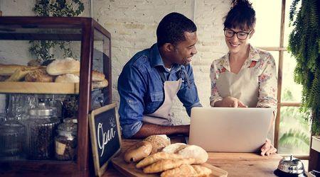 A man and a woman working on a laptop.