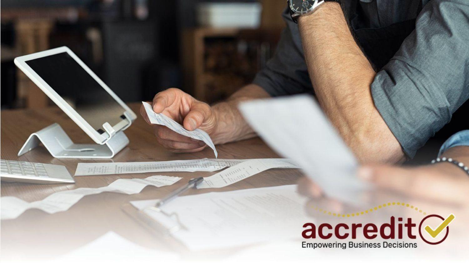 Person looking at a receipt.