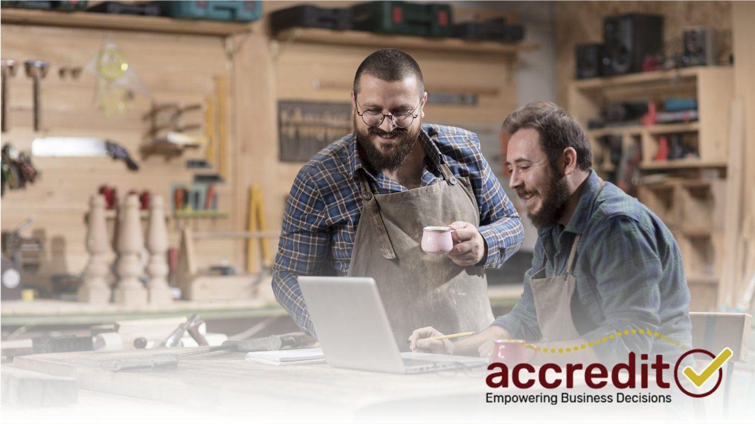 Two men working on a laptop.