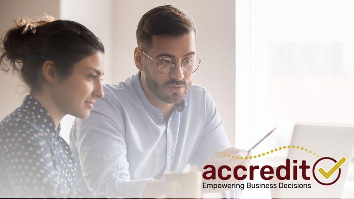 Two people looking at a report.