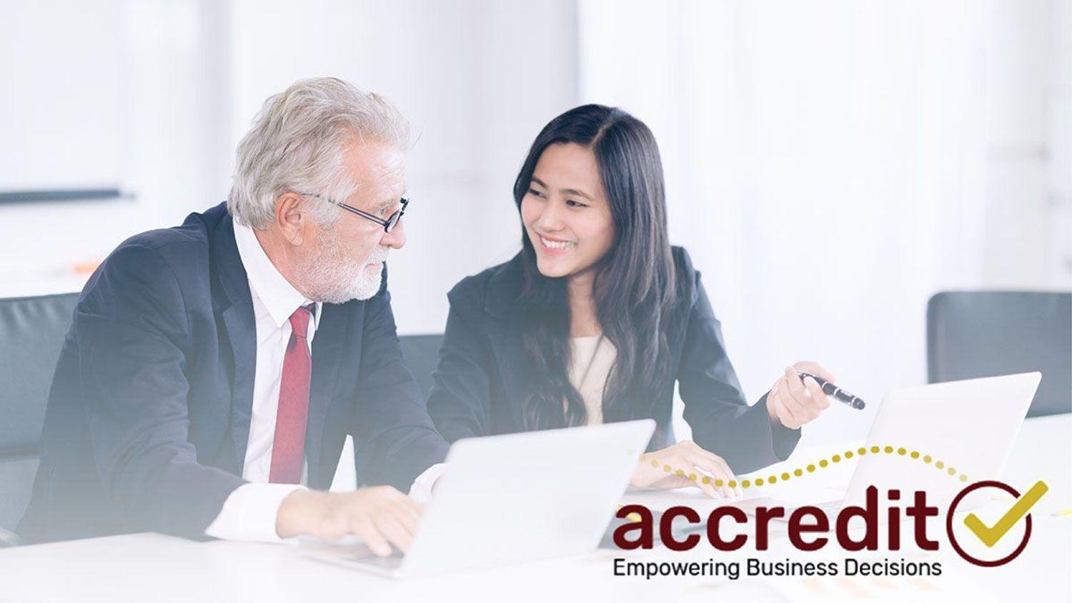 Two people looking at a report.