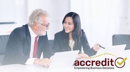 Two people looking at a report.