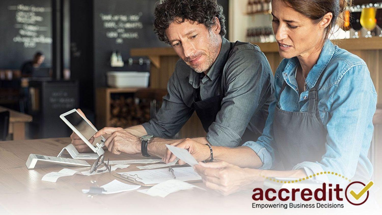 Two people looking at receipts.