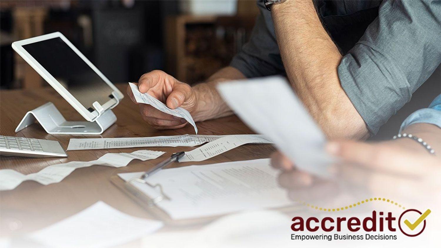 Person looking at a receipt.