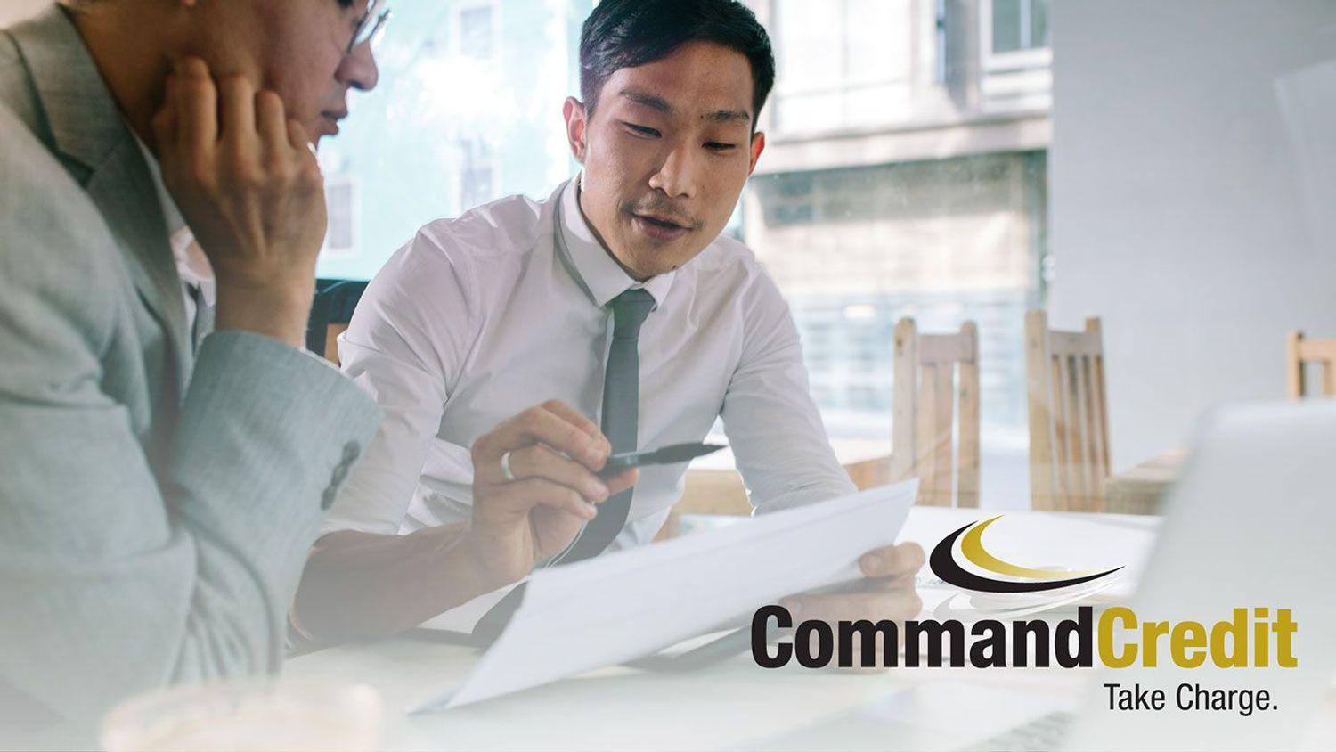 Two people in an office, reviewing a report.