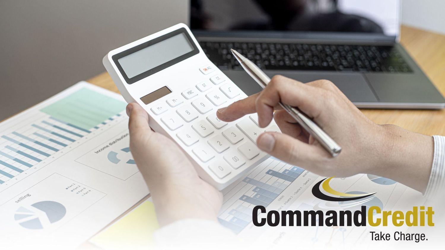 A close up of a person's hands, entering numbers into a calculator. The Command Credit logo is in the bottom right corner.