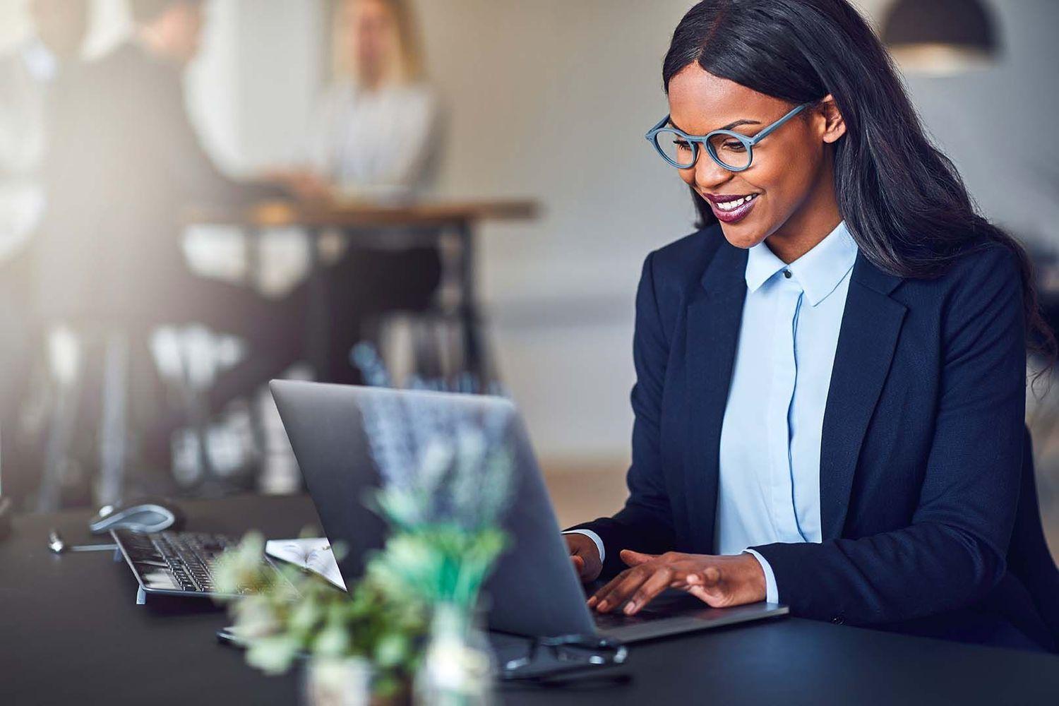 Woman working on laptop.