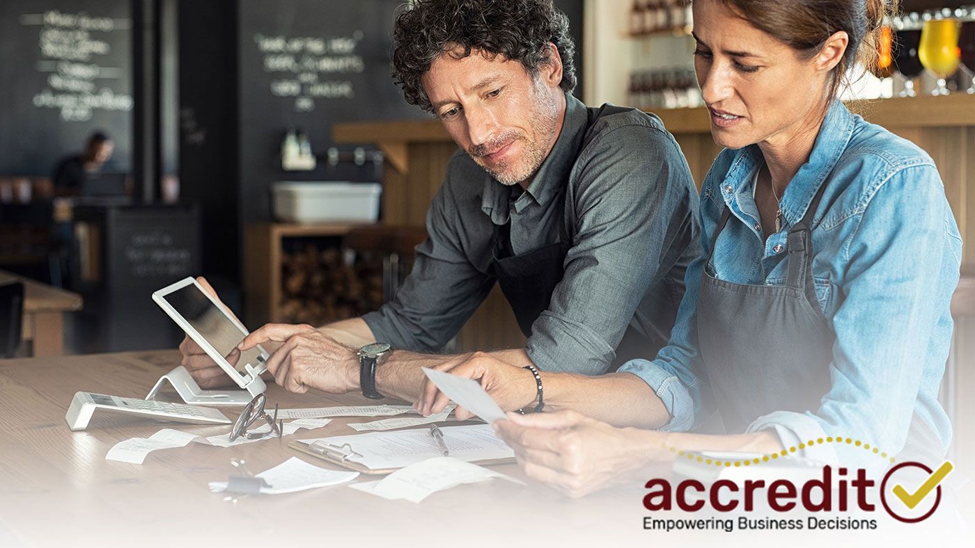 Two people looking at receipts.